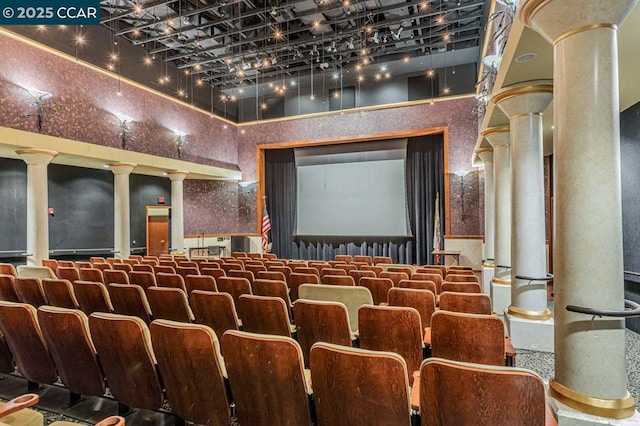 cinema room with ornate columns and a towering ceiling