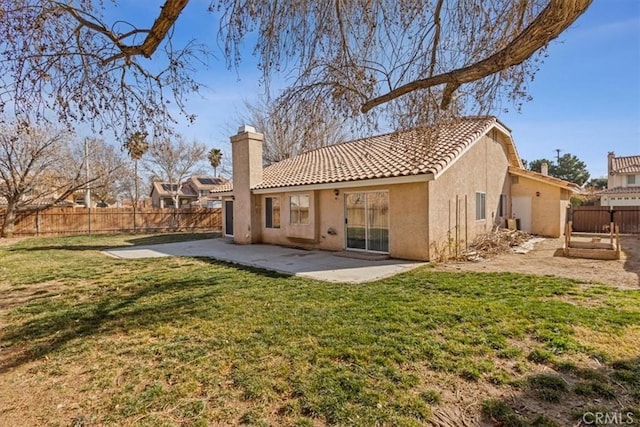 rear view of property featuring a yard and a patio