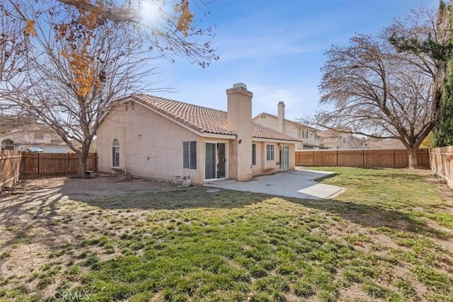 back of property with a patio and a lawn