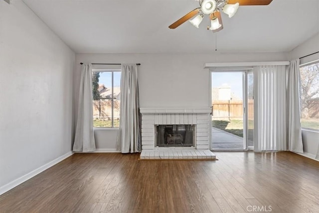 unfurnished living room featuring hardwood / wood-style floors, a fireplace, and ceiling fan