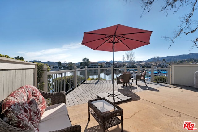 deck featuring a water and mountain view