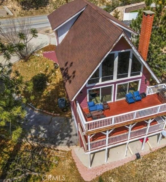 rear view of house featuring cooling unit and a wooden deck