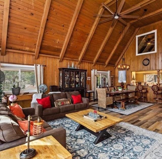 living room featuring wood-type flooring, vaulted ceiling with beams, wooden ceiling, and wooden walls