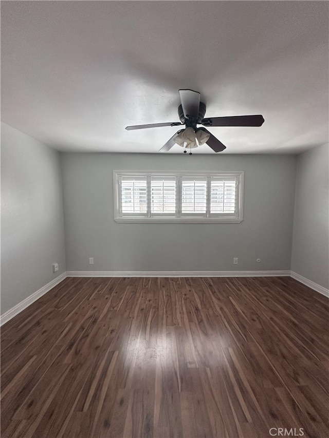 unfurnished room featuring dark hardwood / wood-style floors and ceiling fan