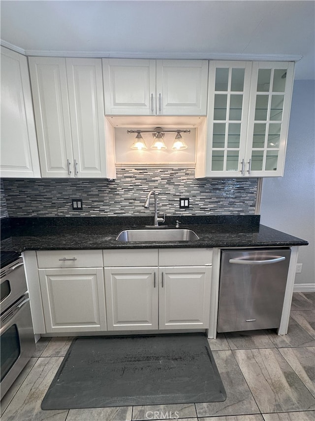 kitchen featuring white cabinetry, sink, tasteful backsplash, and stainless steel dishwasher