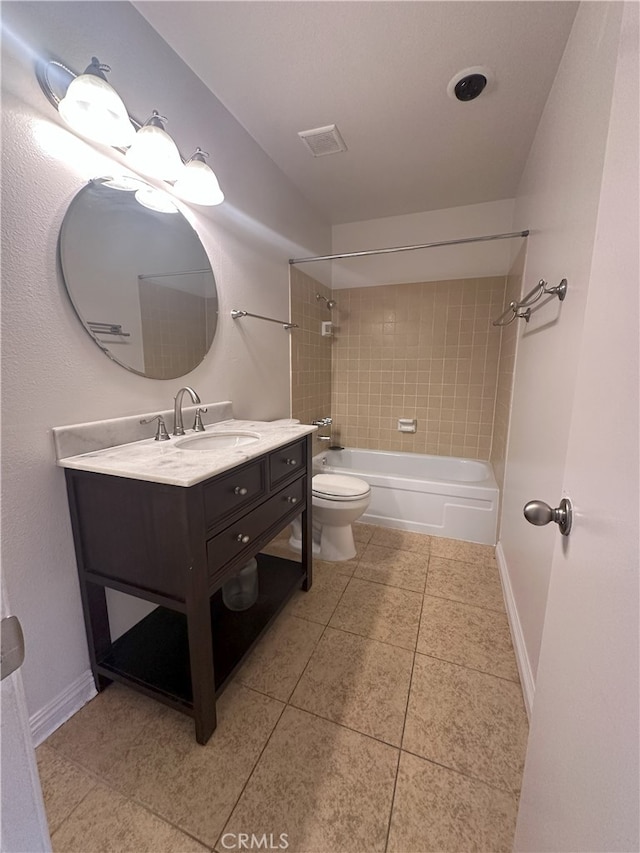 full bathroom featuring tiled shower / bath, vanity, tile patterned floors, and toilet