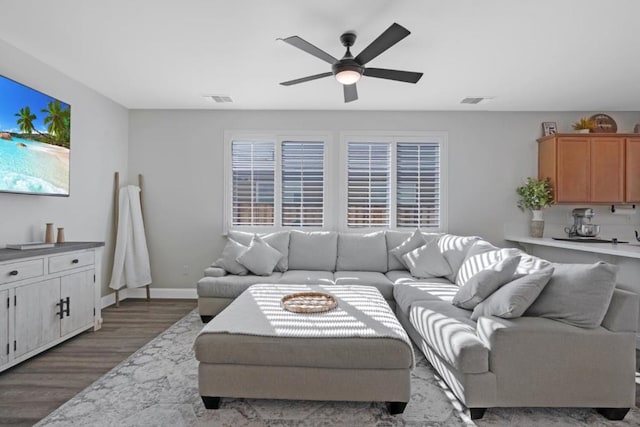 living room with wood-type flooring and ceiling fan