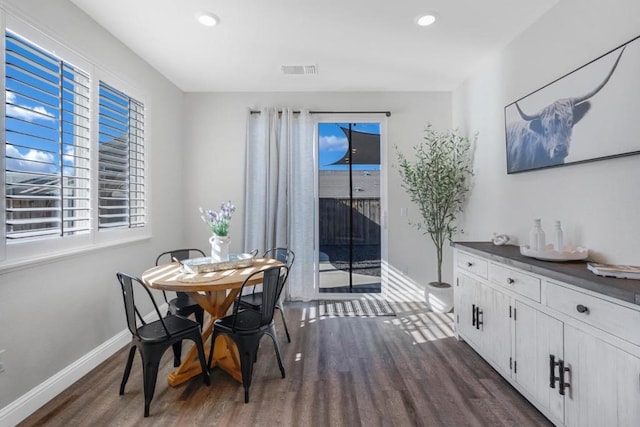 dining area with plenty of natural light and dark hardwood / wood-style flooring