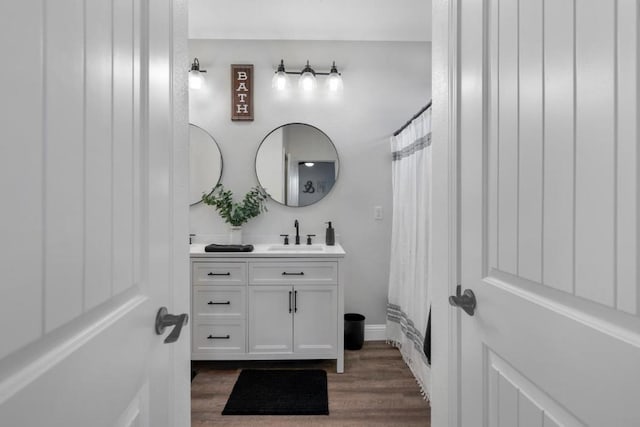 bathroom featuring vanity, wood-type flooring, and a shower with shower curtain