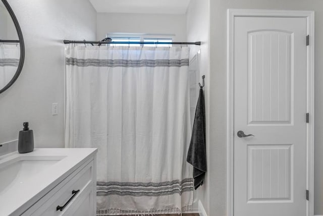 bathroom featuring vanity and a shower with shower curtain