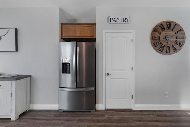 kitchen with dark wood-type flooring and stainless steel fridge with ice dispenser