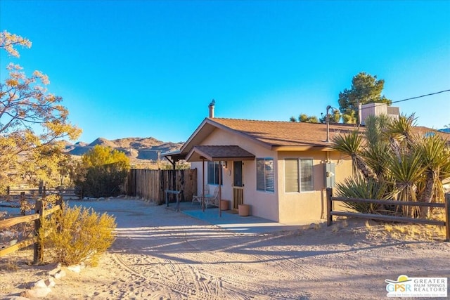 view of front of house with a mountain view and a patio area