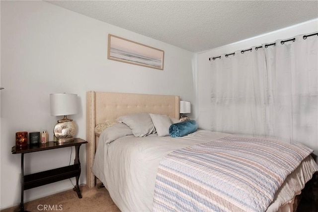 bedroom featuring carpet floors and a textured ceiling