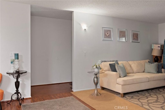 living room with dark wood-type flooring and a textured ceiling