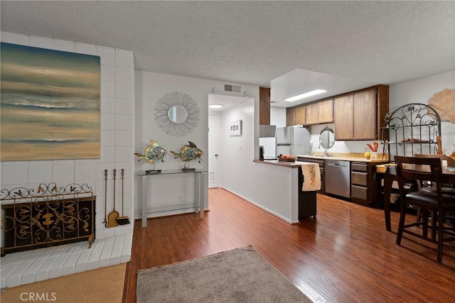 23617 Golden Springs Dr Unit K19, Diamond Bar, CA 91765 - kitchen with stainless steel dishwasher, wood finished floors, a textured ceiling, freestanding refrigerator, and light countertops