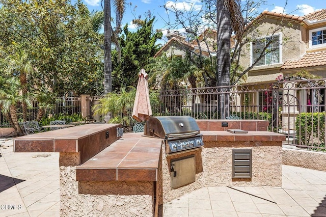 view of patio with grilling area and exterior kitchen