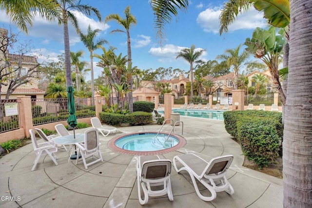 view of pool with a patio and a community hot tub