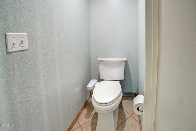 bathroom with tile patterned flooring and toilet