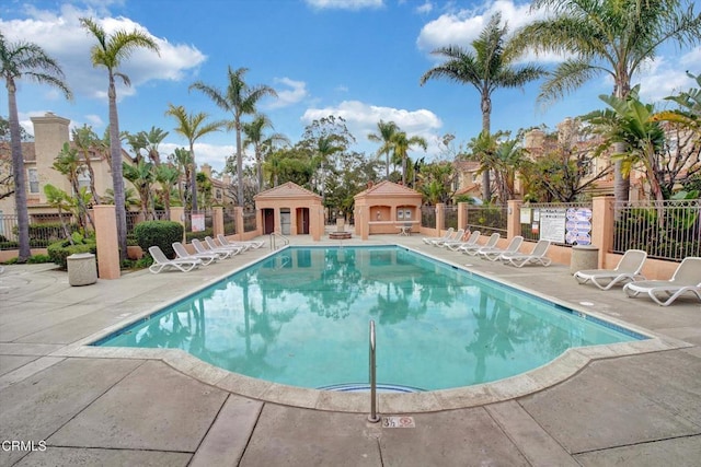 view of swimming pool with a fireplace and a patio area