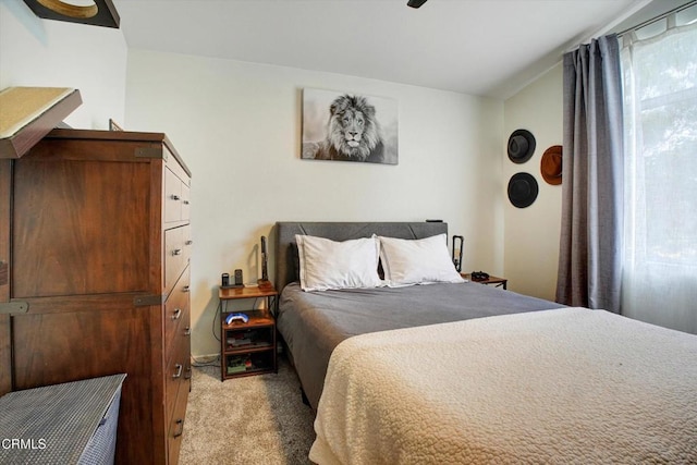 bedroom with ceiling fan and light colored carpet