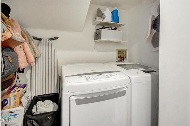 clothes washing area featuring washer and dryer