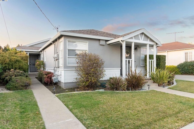 bungalow-style house with a lawn