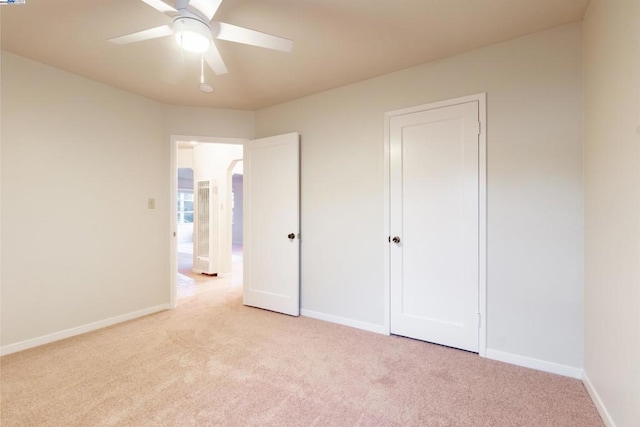 unfurnished bedroom featuring ceiling fan and light carpet