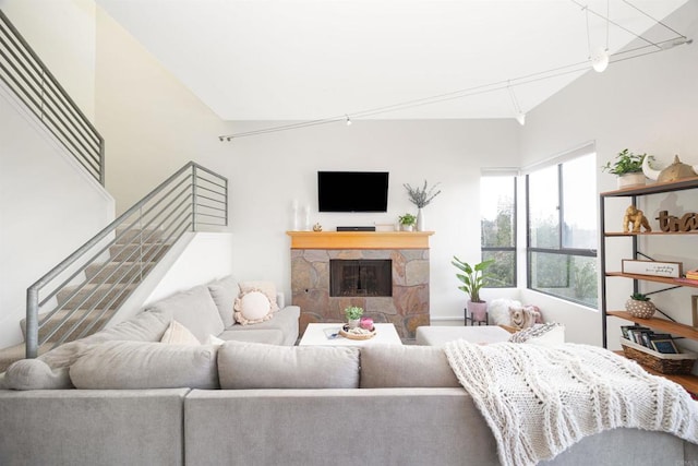 living room featuring a fireplace and vaulted ceiling