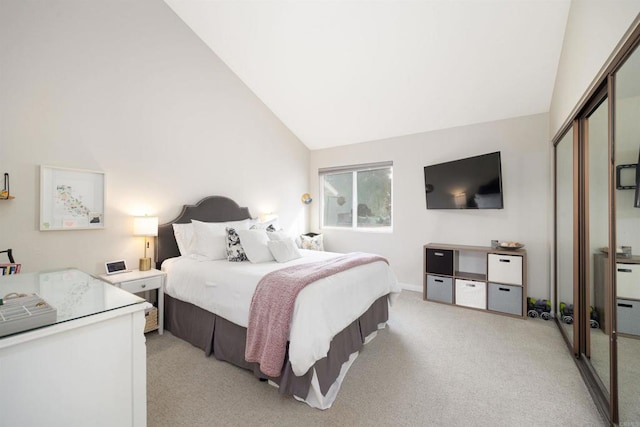 bedroom with light carpet, vaulted ceiling, and a closet