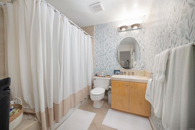 bathroom featuring vanity, tile patterned floors, and toilet