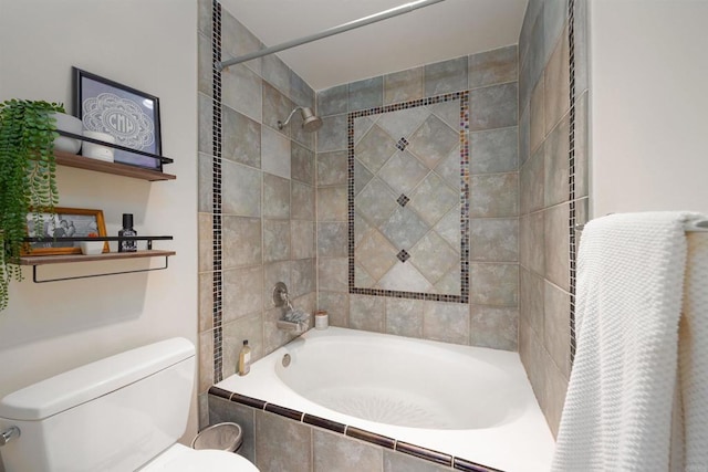 bathroom with toilet and tiled shower / bath combo