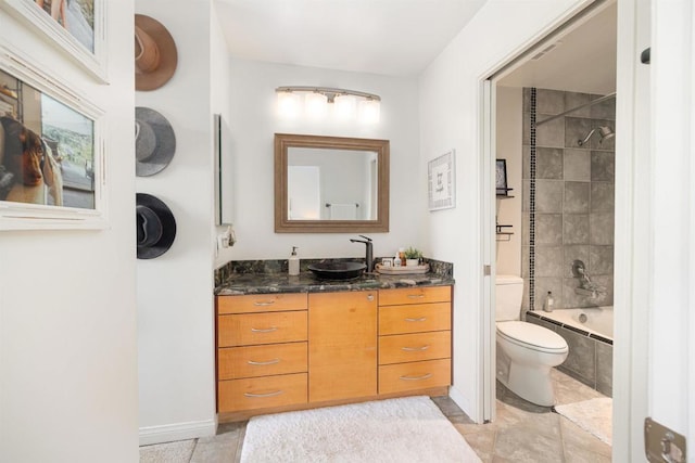 full bathroom with vanity, tile patterned floors, toilet, and tiled shower / bath