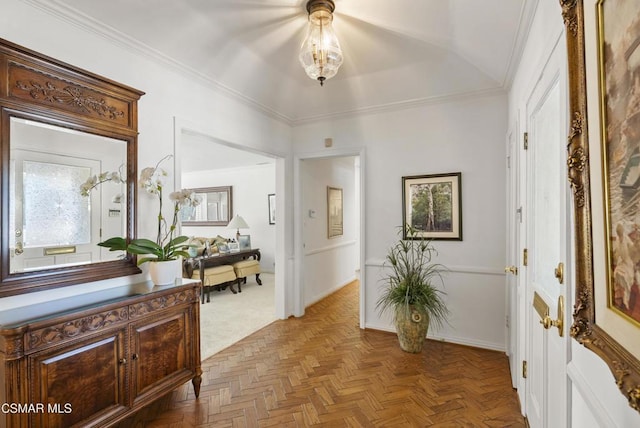 interior space featuring ornamental molding and light parquet flooring