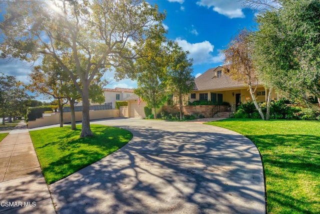 view of front of house featuring a garage and a front lawn