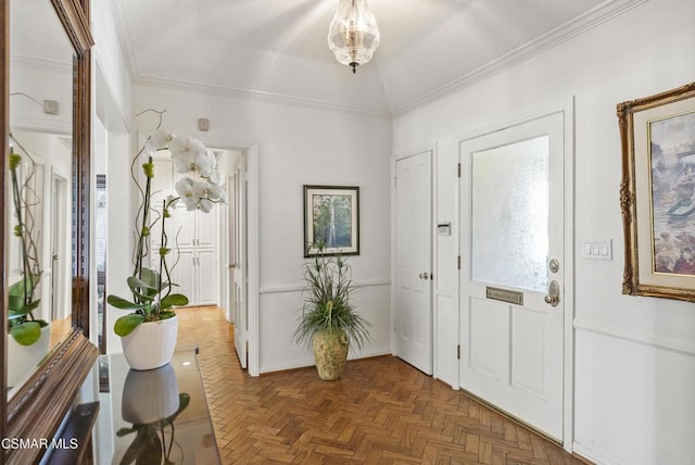 entrance foyer with crown molding, vaulted ceiling, and dark parquet floors