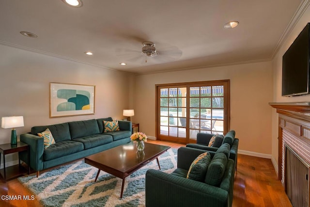 living room featuring ornamental molding, hardwood / wood-style floors, and ceiling fan