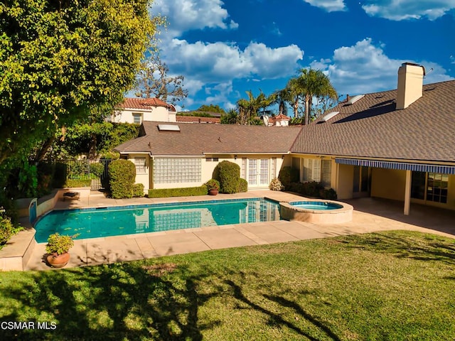 view of pool featuring an in ground hot tub, a yard, and a patio