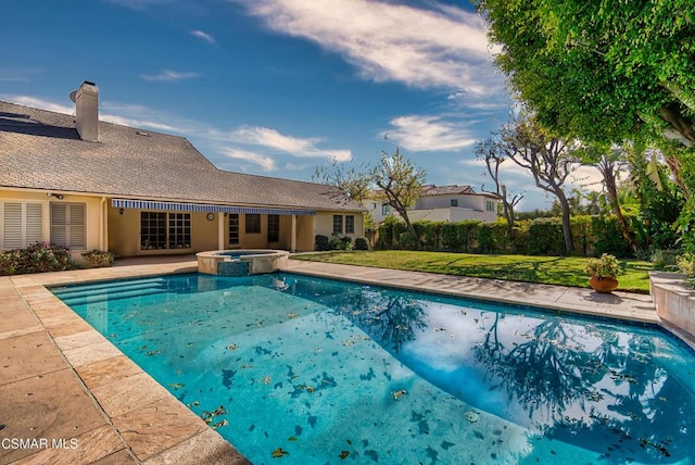 view of swimming pool with a yard and an in ground hot tub