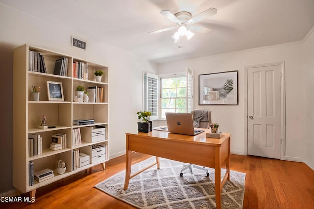 home office with hardwood / wood-style flooring and ceiling fan