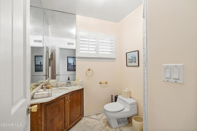 bathroom with vanity and toilet