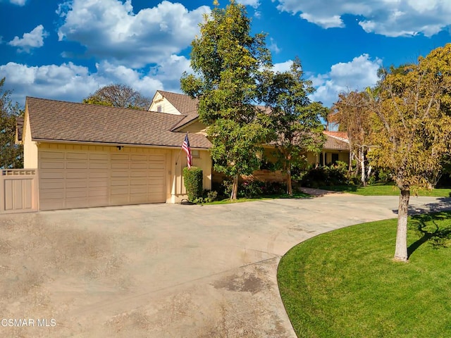 view of front of house featuring a garage and a front lawn