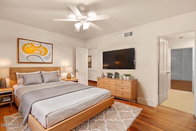 bedroom with wood-type flooring and ceiling fan