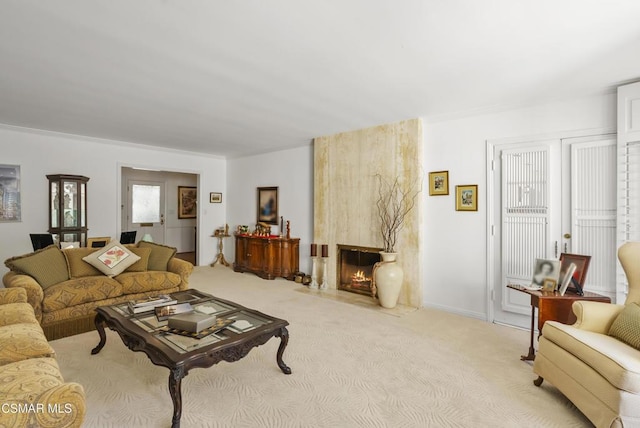 carpeted living room with a premium fireplace