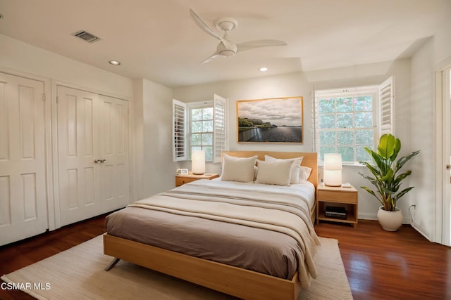 bedroom with dark hardwood / wood-style floors and ceiling fan