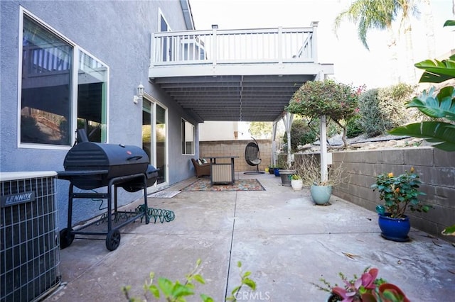 view of patio / terrace with a balcony, grilling area, and central air condition unit