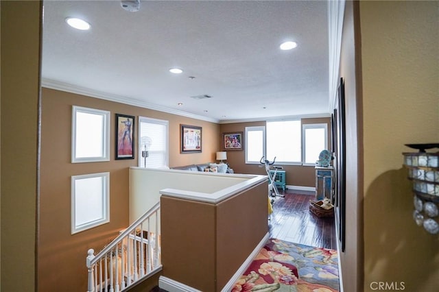 interior space featuring ornamental molding, dark hardwood / wood-style flooring, and kitchen peninsula