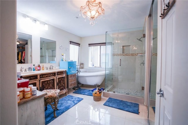 bathroom featuring an inviting chandelier, vanity, shower with separate bathtub, and tile patterned flooring