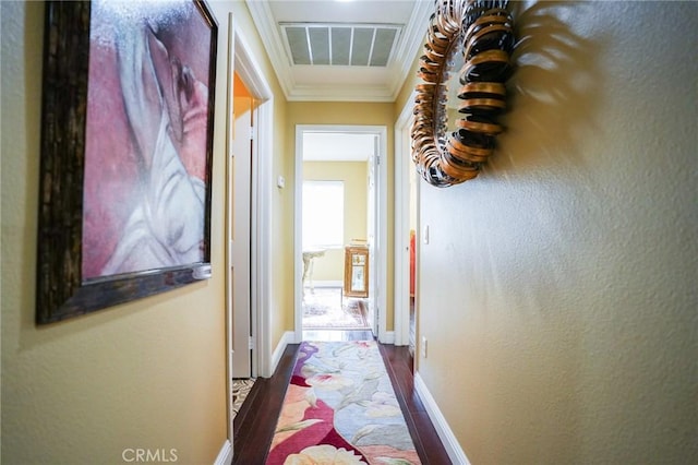 hallway featuring wood-type flooring and ornamental molding