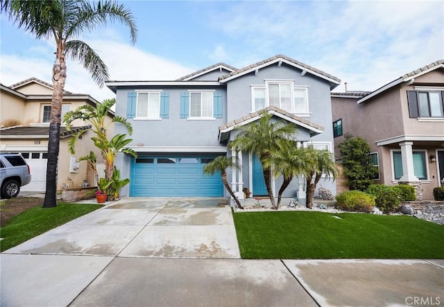 view of front of property featuring a garage and a front yard