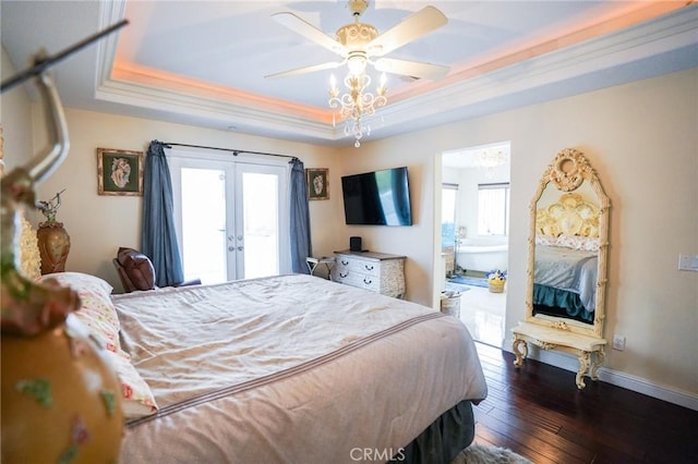 bedroom with ensuite bathroom, french doors, dark hardwood / wood-style flooring, access to outside, and a raised ceiling